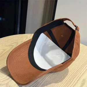 Brown washed baseball cap detail view, casual cotton hat with inner lining and adjustable strap.