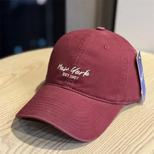 Burgundy cotton baseball cap featuring embroidered New York lettering for casual outdoor daily wear.