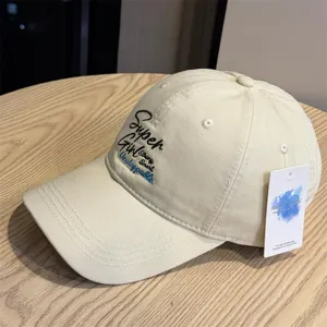 Beige embroidered baseball cap with inspirational lettering, soft top casual hat for daily wear.