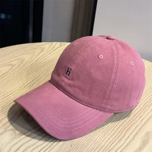 Stylish washed cotton baseball cap for men and women, breathable curved brim sun hat with chic embroidery.