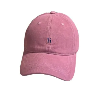 Vintage washed pink baseball hat with embroidered letter hi, soft top casual sun cap.