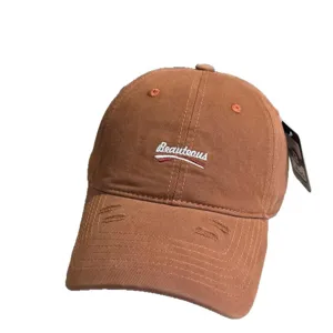 Brown washed distressed baseball cap with embroidered letters for casual street style daily wear.