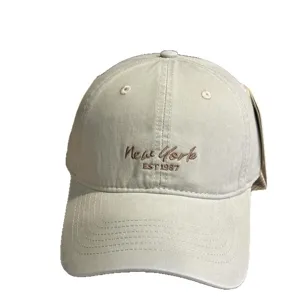 Beige cotton baseball cap with New York embroidery, classic curved brim sun protection hat.