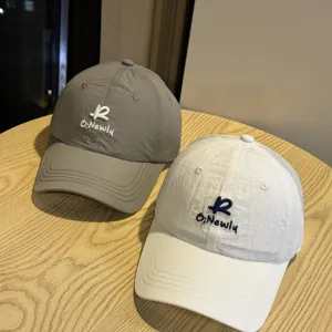 Quick-dry baseball caps in grey and white with embroidered letters, casual sun shade style.