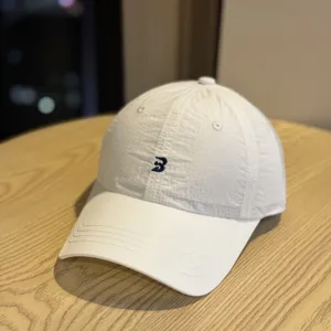 Lightweight quick-drying waterproof white baseball cap featuring minimalist front embroidery detail.