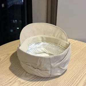 Beige pleated newsboy hat detail, Japanese dark style flat top octagonal cap interior structure.