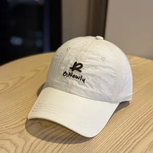 Unisex quick-dry baseball cap with stylish embroidered letters, casual street sun hat detail view.