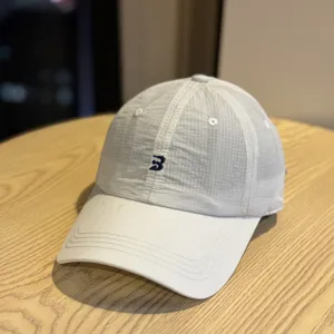 Close-up detail view of lightweight quick-drying mesh baseball cap with embroidered logo.