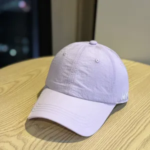 Detail view of the light purple quick-drying baseball cap with side embroidery for summer.