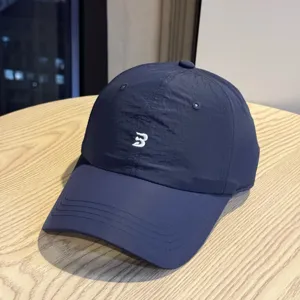 Detail view of the navy blue quick-dry waterproof baseball cap with front embroidered logo.