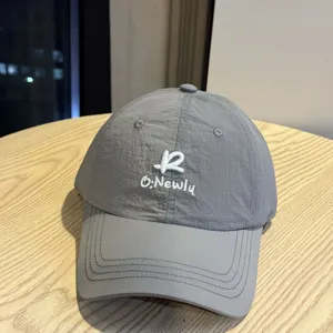 Detailed close-up of the grey quick-dry baseball cap showcasing premium embroidered logo texture.