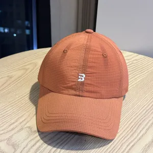 Detail view of quick dry waterproof breathable baseball cap with grid pattern and embroidery.