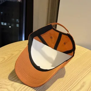 Orange waterproof quick drying baseball cap interior detail showing breathable fabric.
