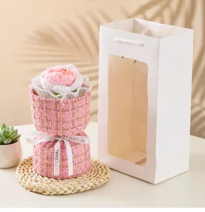 Handmade knitted rose flower bouquet in pink tweed style packaging with gift bag detail.