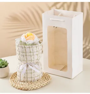 Handmade crochet rose flower bouquet detail view featuring elegant tweed wrapper and gift bag.