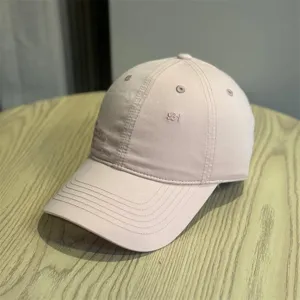 Detailed view of pink vintage baseball cap with delicate embroidery and classic style.