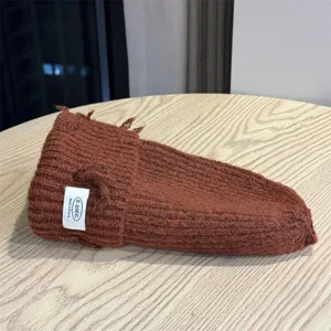Brown slouchy knitted beanie hat detail, cozy winter wool knit texture for women warmth.