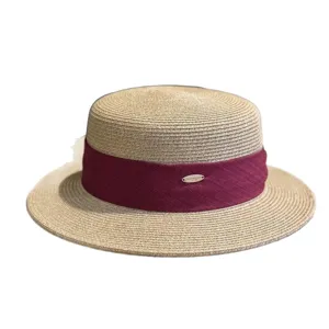 Classic women's straw boater hat, flat top wide brim sun hat with red ribbon for summer chic.