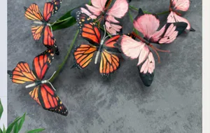 3D butterfly detail view, artificial butterfly window decor props, pink and orange style.
