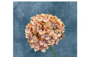 Close-up detail of the artificial orange-brown hydrangea flower head with realistic petals.