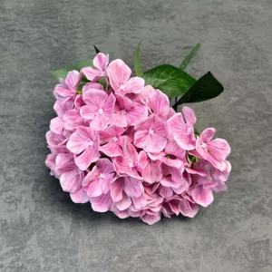 Artificial pink hydrangea flower heads with green leaves for wedding and home decor.