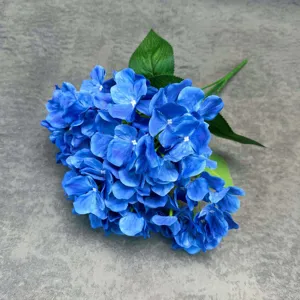 Detailed view of artificial blue hydrangea flower bunch, realistic floral decor for wedding and home.