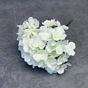 Detailed close-up of white artificial hydrangea flower head, realistic 3D craft for decor.