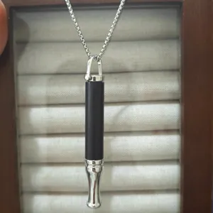 Mindful breathing necklace detail, stainless steel anxiety relief whistle pendant for meditation.