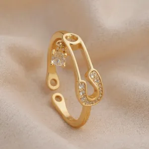 Gold safety pin ring with cubic zirconia, stylish open adjustable fashion jewelry for women.