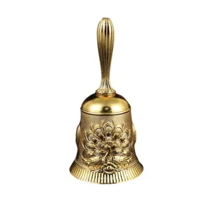 Cloche à main dorée vintage avec motif de paon en relief, idéale pour table ou salle de classe.