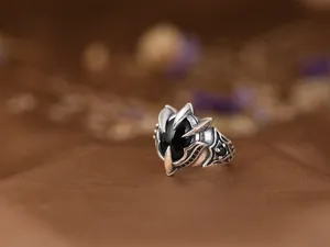 Detailed close-up shot of retro oxidized eagle claw ring featuring black zircon stone