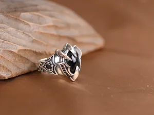 Close-up view of vintage retro silver gothic eagle claw ring featuring sparkling black zircon.