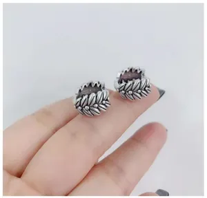 Vintage wheat ear silver ring detail close-up showing intricate leaf carved texture.