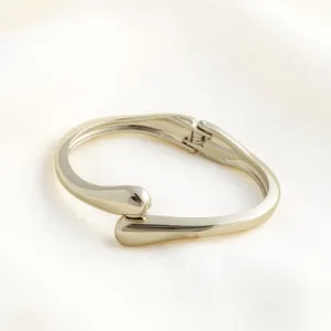 Minimalist metal open bangle bracelet, sleek geometric teardrop design for modern fashion women.