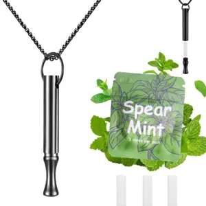 Detail view of the black stainless steel meditation breathing necklace with mint core props.