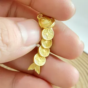 Gold coin fish pendant jewelry detail shot showcasing intricate traditional Chinese coin design.