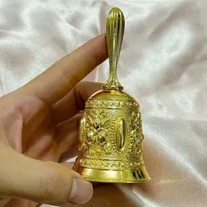 Vintage gold metal hand bell with exquisite embossed floral pattern for dining or classroom use.