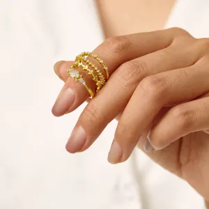 Squisito set di 4 anelli impilabili con zirconi scintillanti e design a foglia elegante.