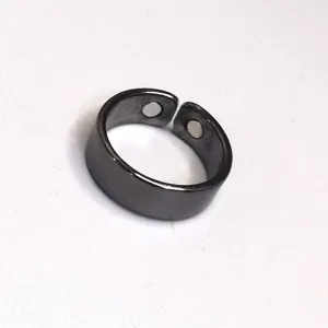 Detail view of the black metallic open adjustable health magnetic ring showing inner dual magnets.