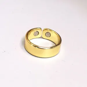 Close-up view of gold open magnetic health ring showing inner magnetic beads detail.