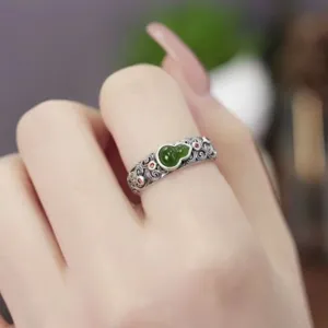 Vintage sterling silver gourd ring featuring green jade detail and retro filigree pattern.