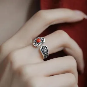 Detailed close-up of vintage Thai silver open ring featuring ruyi cloud and red stone accent.