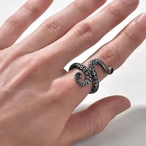 Detailed close-up view of vintage punk style octopus tentacle ring worn on human finger.
