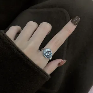 Close-up detail shot of vintage plain silver koi fish and lotus seedpod open ring design.
