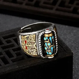 Bague tibétaine en argent avec perle dzi rotative et turquoise, vue de détail rétro.