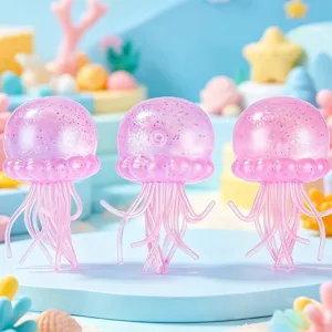 Close-up detail shot of cute pink glitter jellyfish squishy toys on ocean display platform.