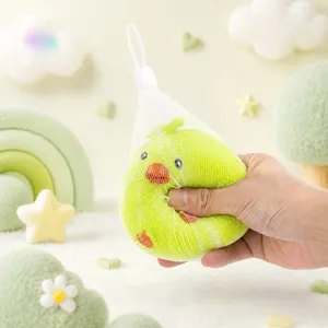 Close-up of cute green chick squishy toy in mesh bag, showing slow rebound texture.