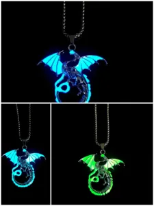 Close up detail of glowing dragon pendant necklace showing brilliant luminous effect in the dark.