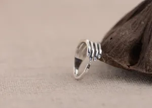 Vintage sterling silver hand hug open ring with creative design, artistic jewelry detail.