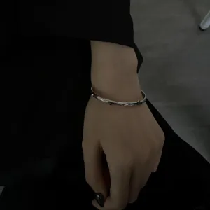 Minimalist silver thorn bracelet detail shot, retro twig open cuff for men and women stylish.